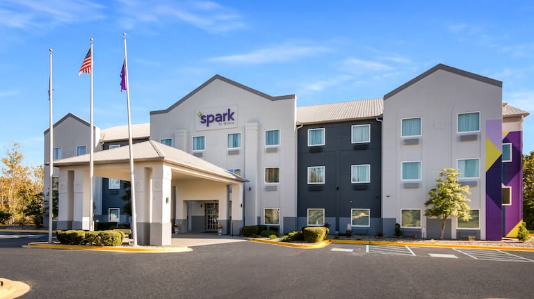 Exterior of Spark by Hilton beneath a blue sky